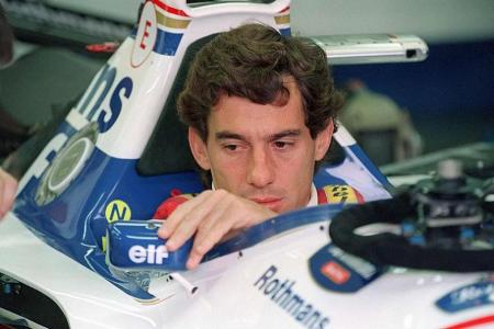 Brazilian F1 driver Ayrton Senna adjusts his rear view mirror in the pits 01 May 1994 before the start of the San Marino Grand Prix. Senna died after crashing in the seventh lap.