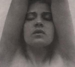 Tina_Modotti_with_her_arms_raised_-_Edward_Weston_restoration